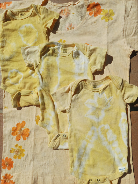 Yellow tie-dye shirt on a floral-patterned surface